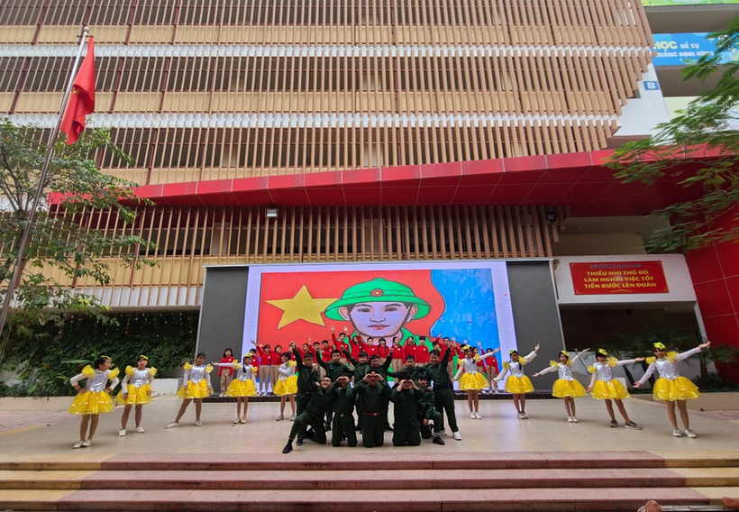 A group of people in yellow uniforms marching in front of a building

Description automatically generated with low confidence