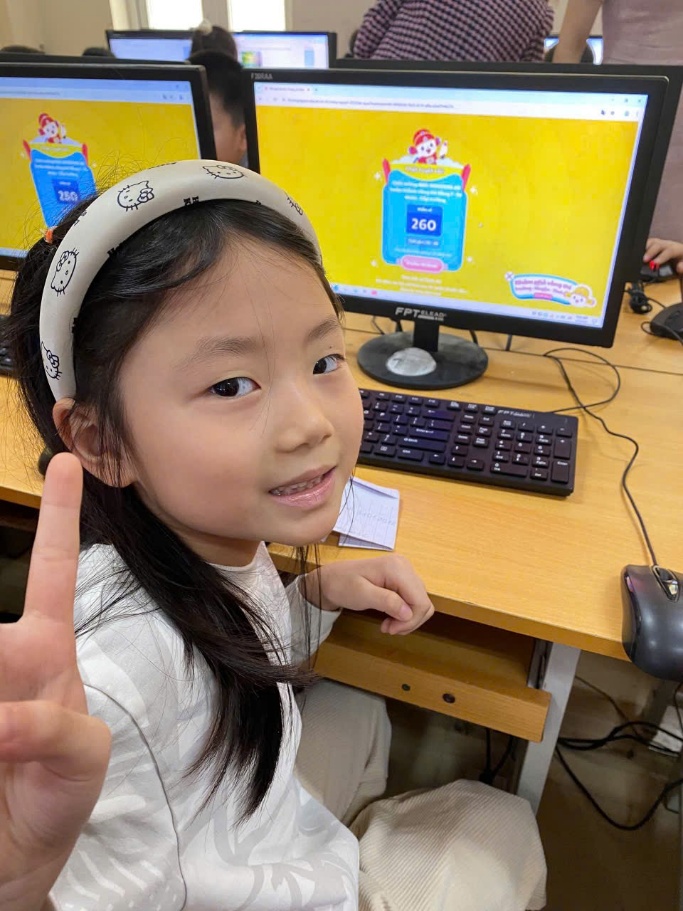 A child sitting at a desk with a hand up
AI-generated content may be incorrect.