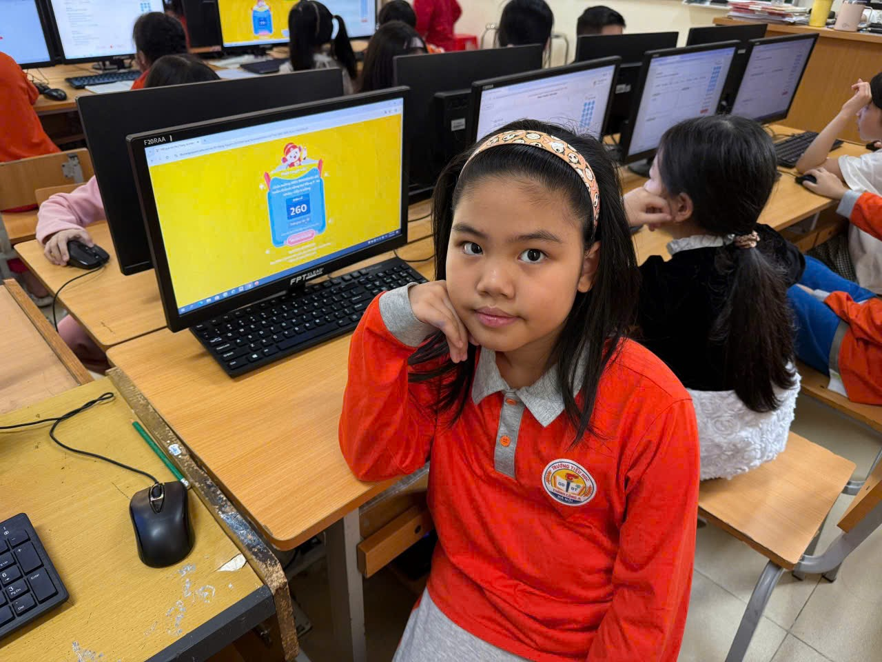 A child sitting at a desk with computers
AI-generated content may be incorrect.