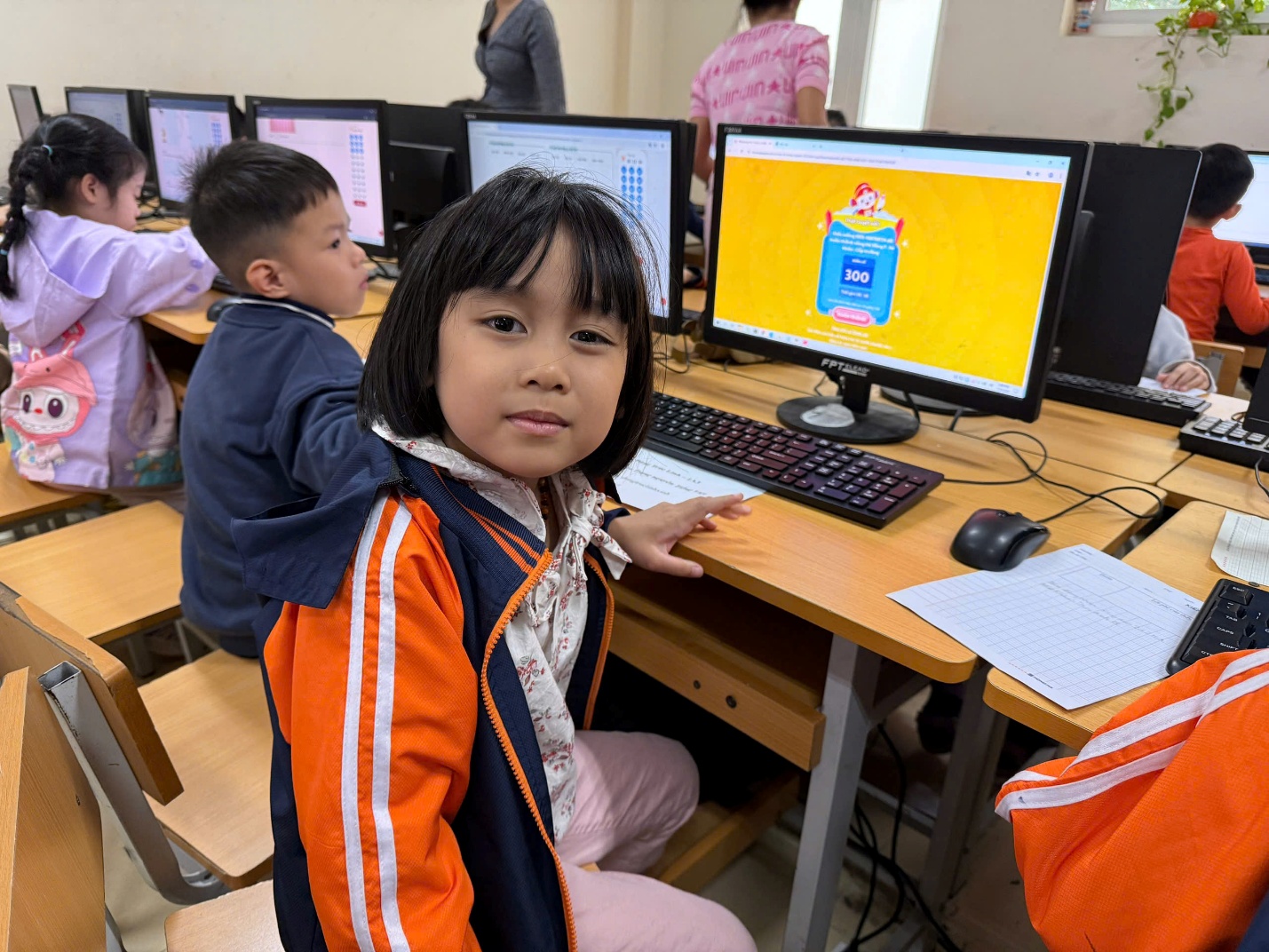 A child sitting at a desk with a computer
AI-generated content may be incorrect.