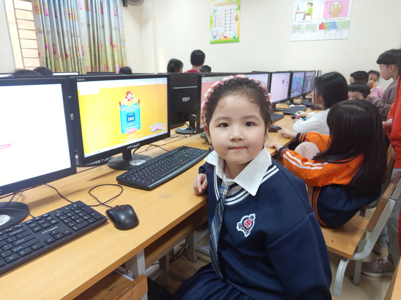 A child sitting in front of a computer
AI-generated content may be incorrect.