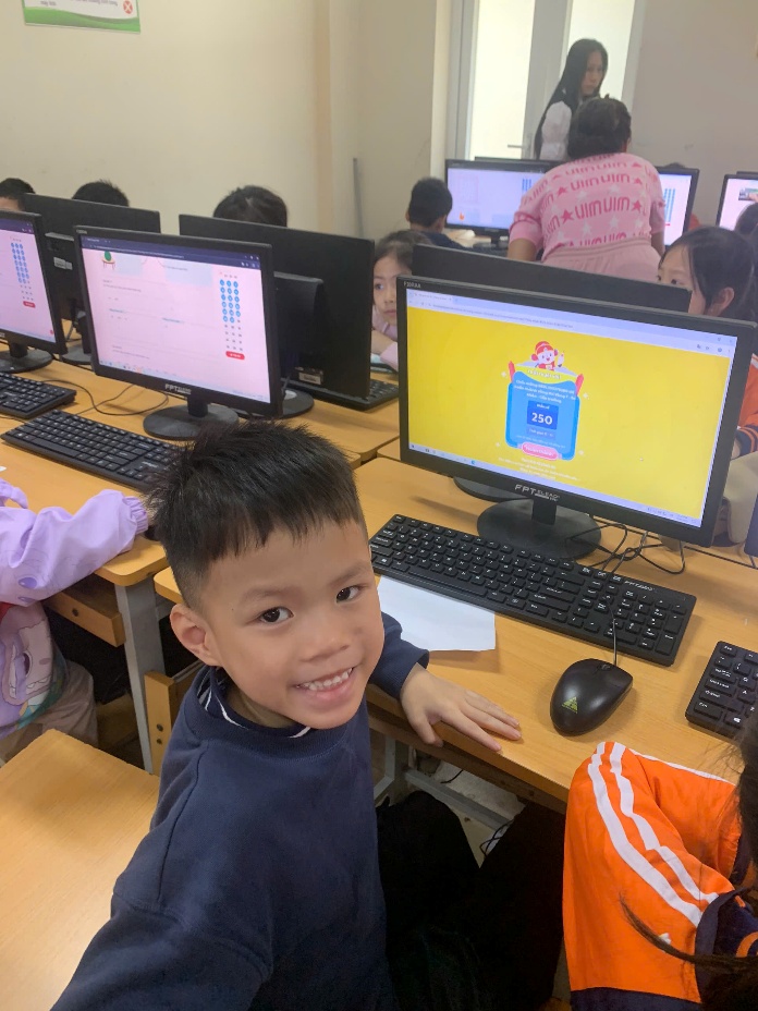 A child sitting at a desk with computers
AI-generated content may be incorrect.