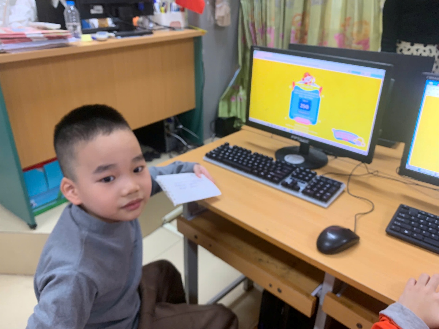 A child sitting at a desk with a computer
AI-generated content may be incorrect.