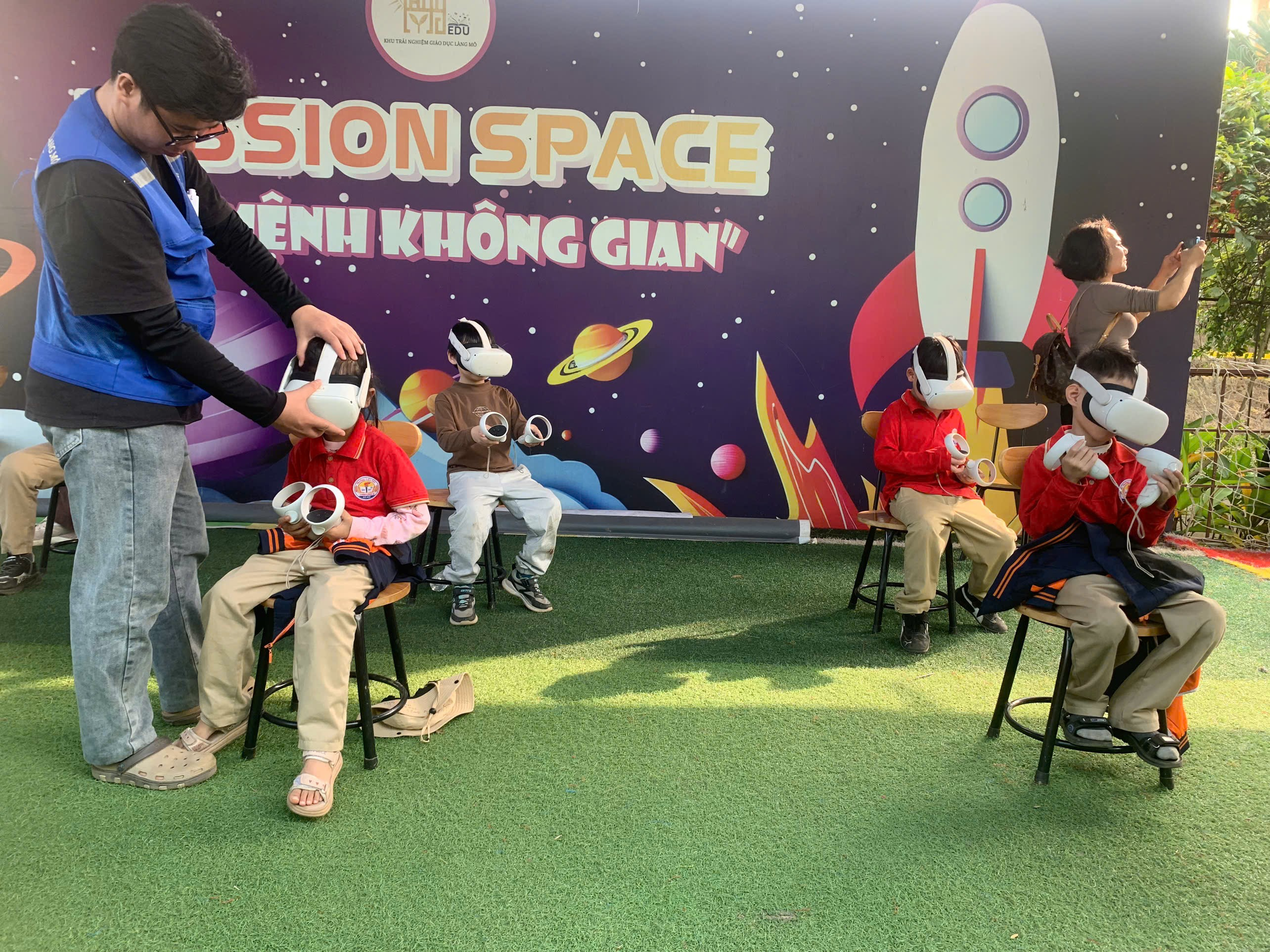 A group of people sitting in chairs with a person putting a helmet on
AI-generated content may be incorrect.