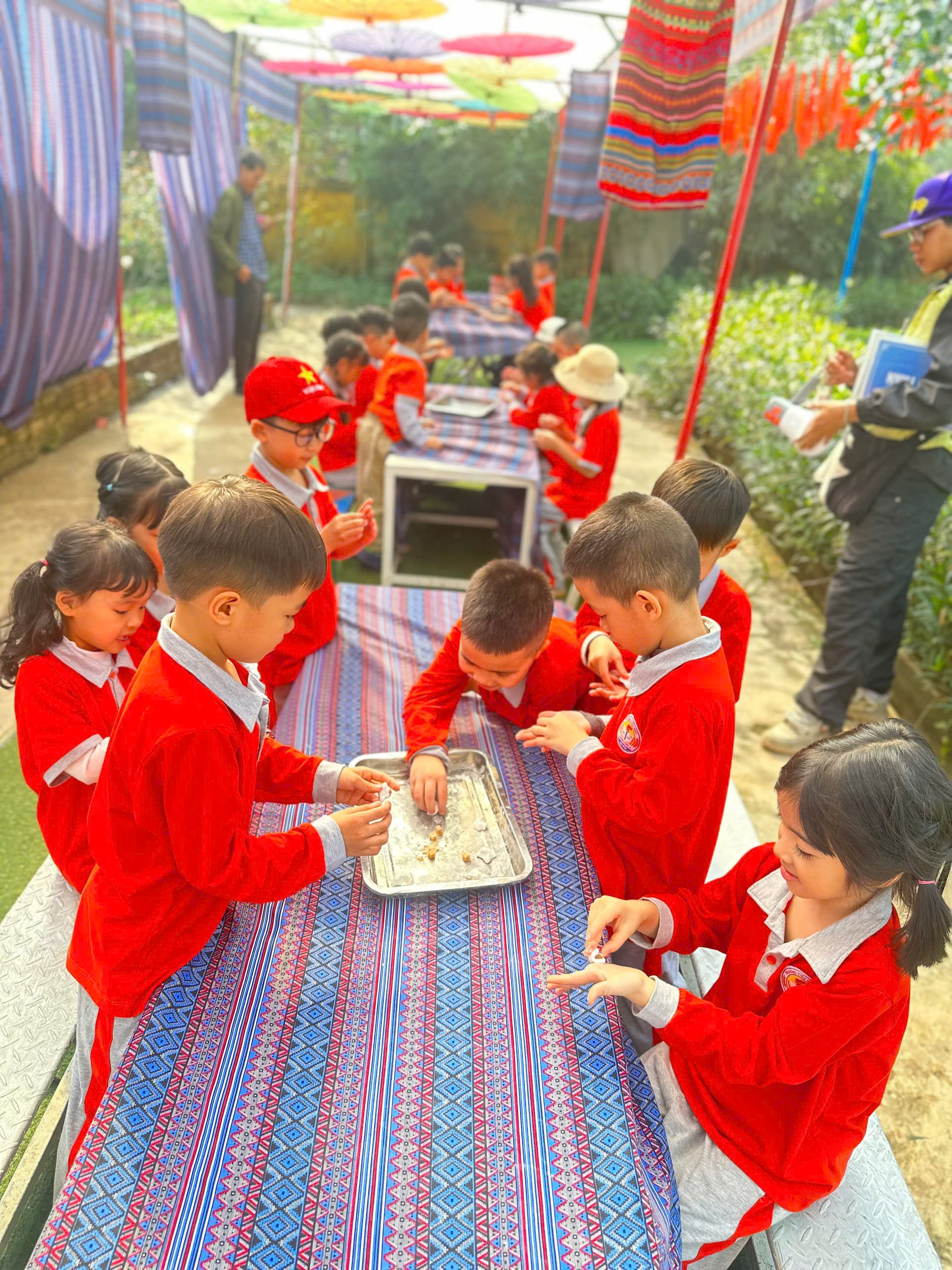 A group of children in red uniforms at a table
AI-generated content may be incorrect.