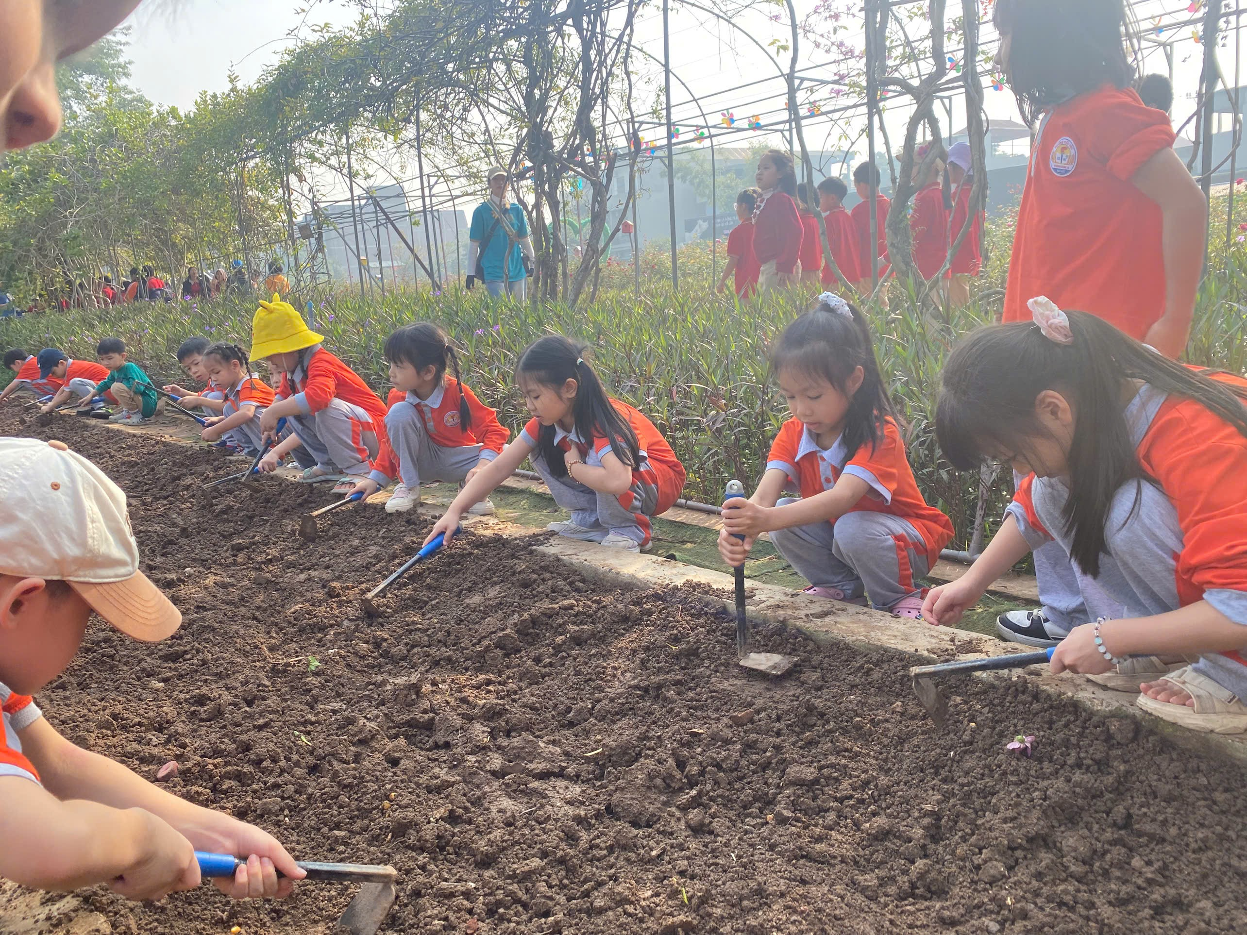 A group of children planting a garden
AI-generated content may be incorrect.