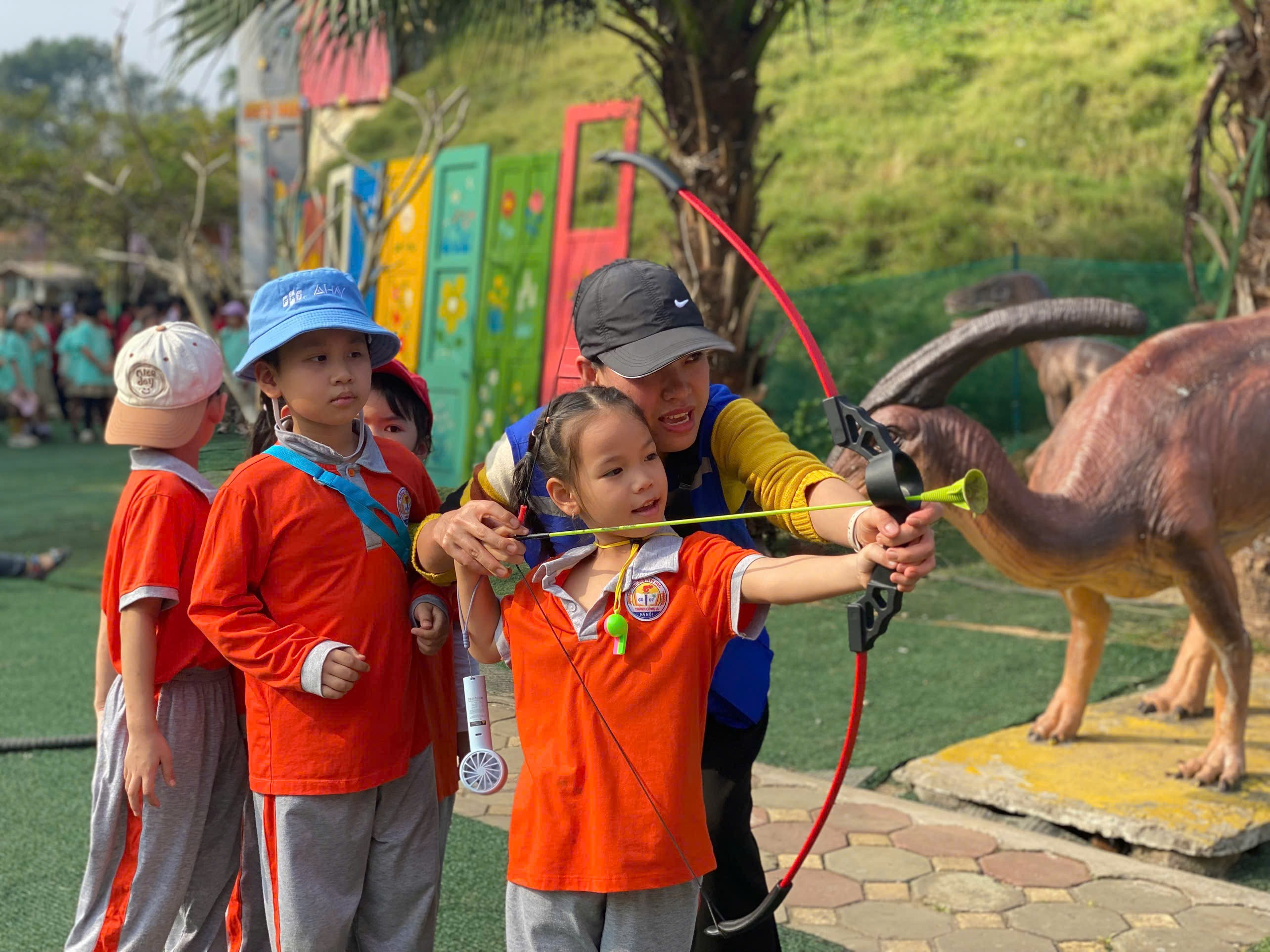 A group of children shooting a bow and arrow
AI-generated content may be incorrect.