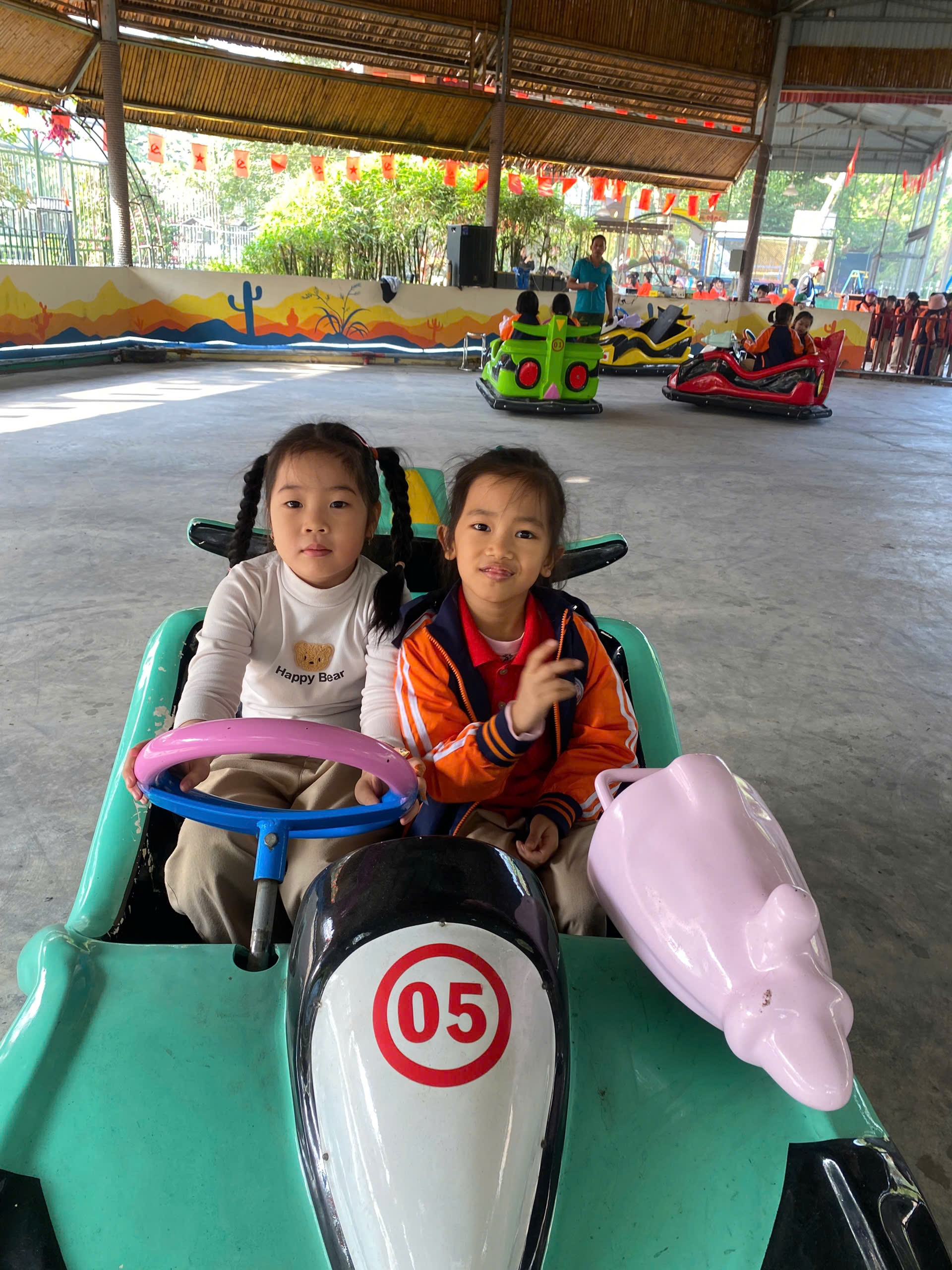 Two children in a toy car
AI-generated content may be incorrect.