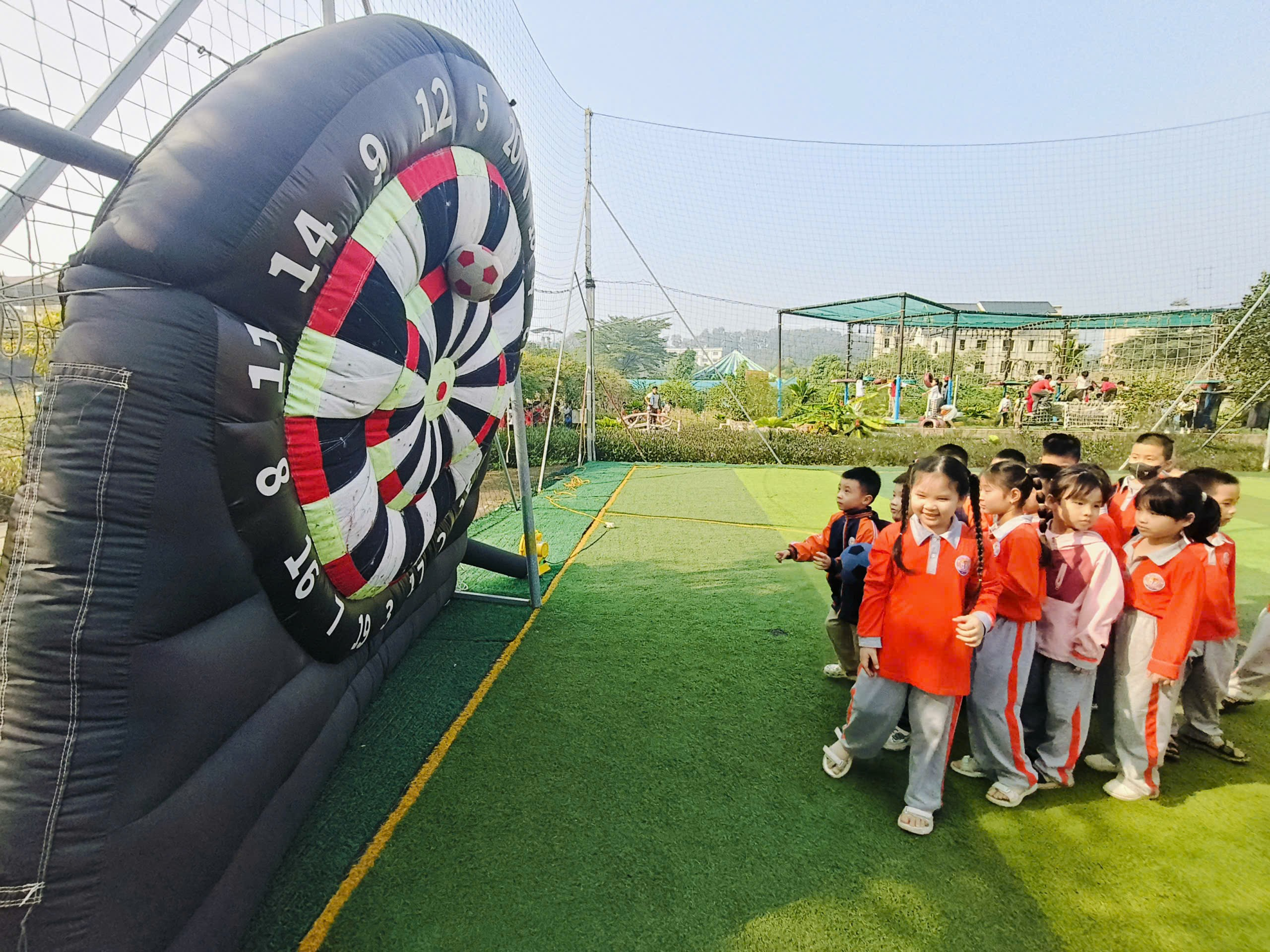 A group of children standing next to a dart board
AI-generated content may be incorrect.
