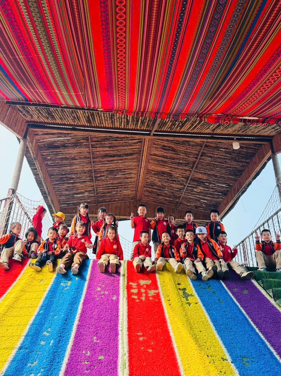 A group of children sitting on a rainbow colored stairs
AI-generated content may be incorrect.