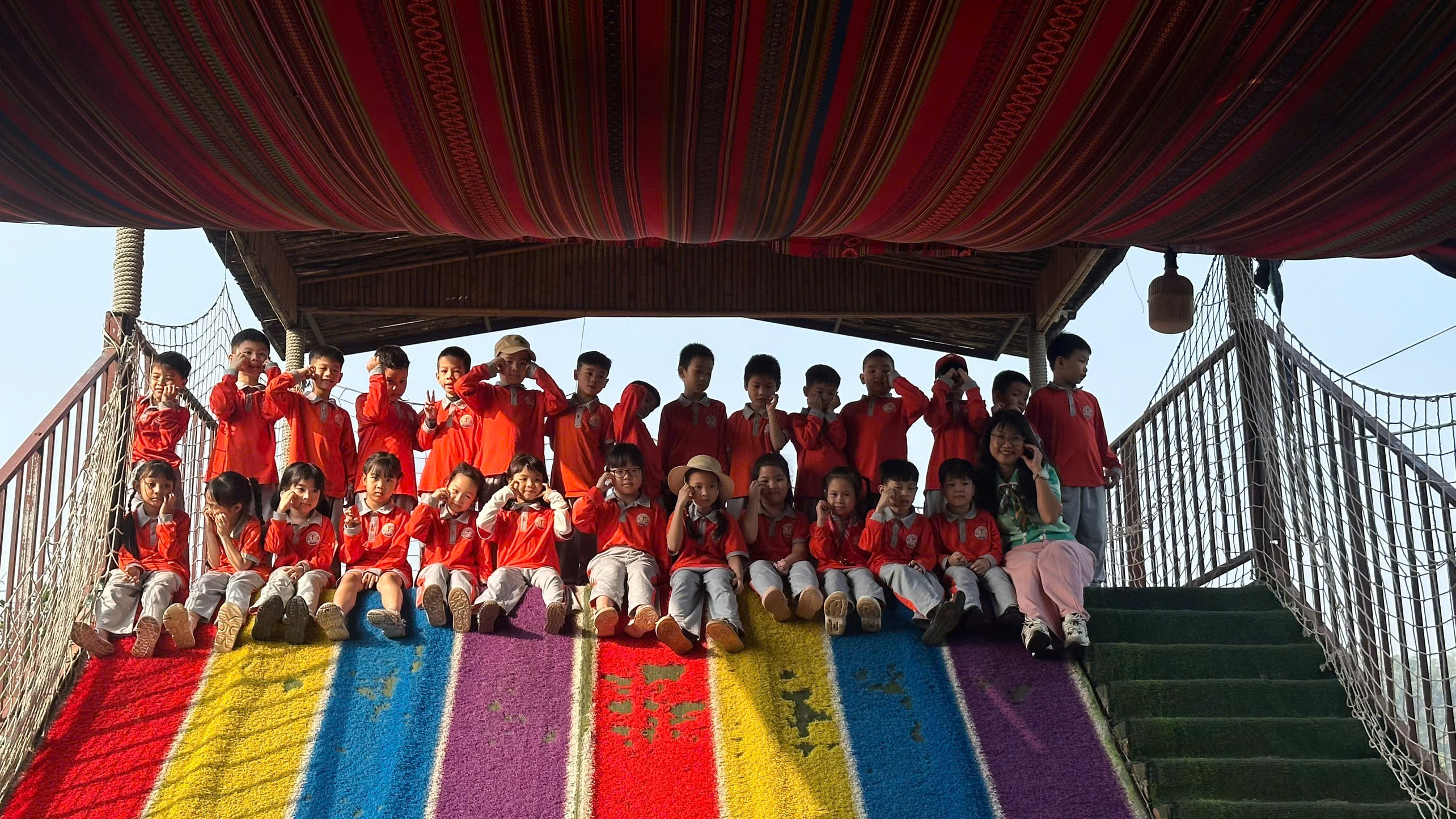 A group of children sitting on a colorful staircase
AI-generated content may be incorrect.