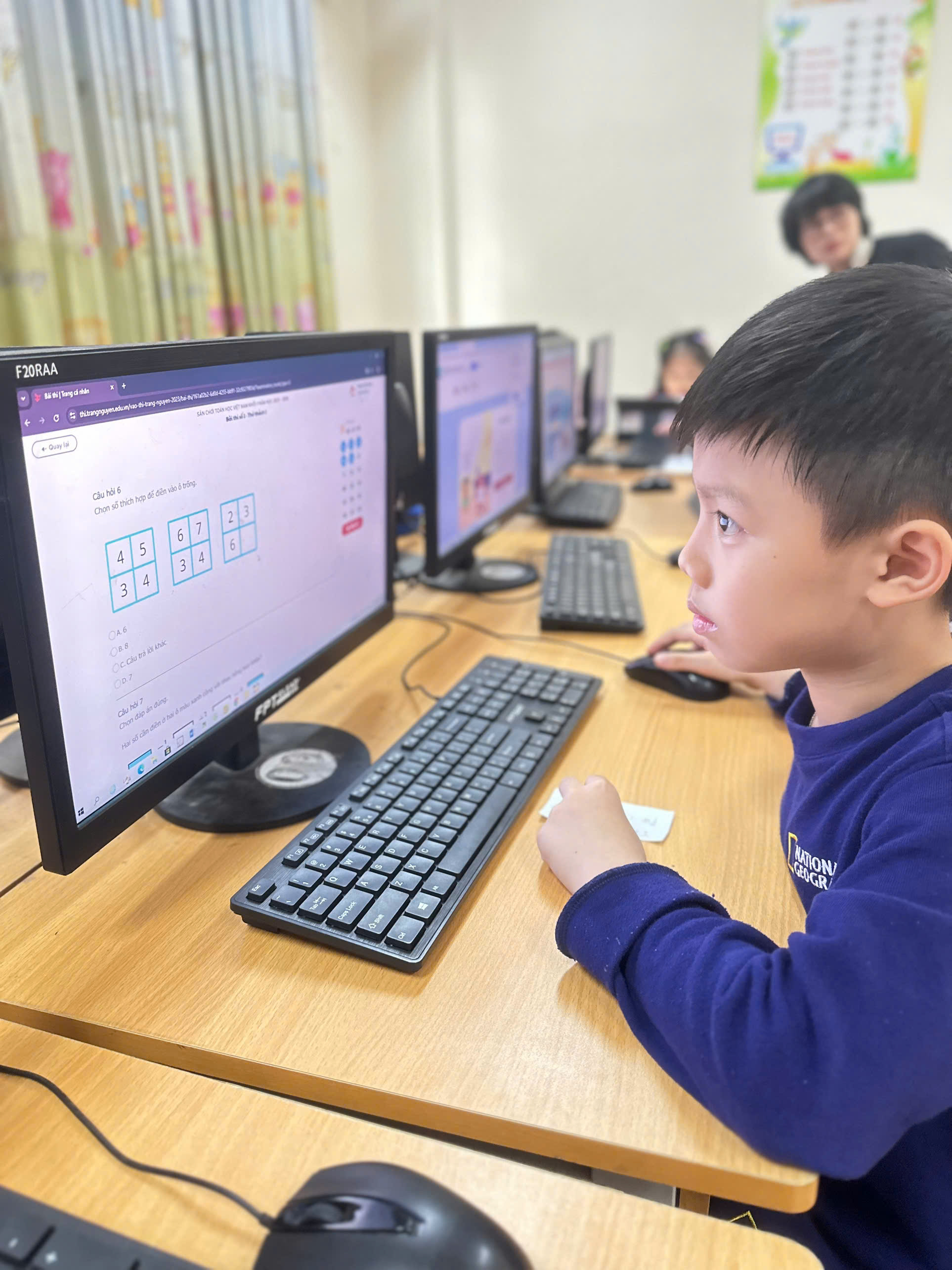 A child sitting at a desk with computers

AI-generated content may be incorrect.