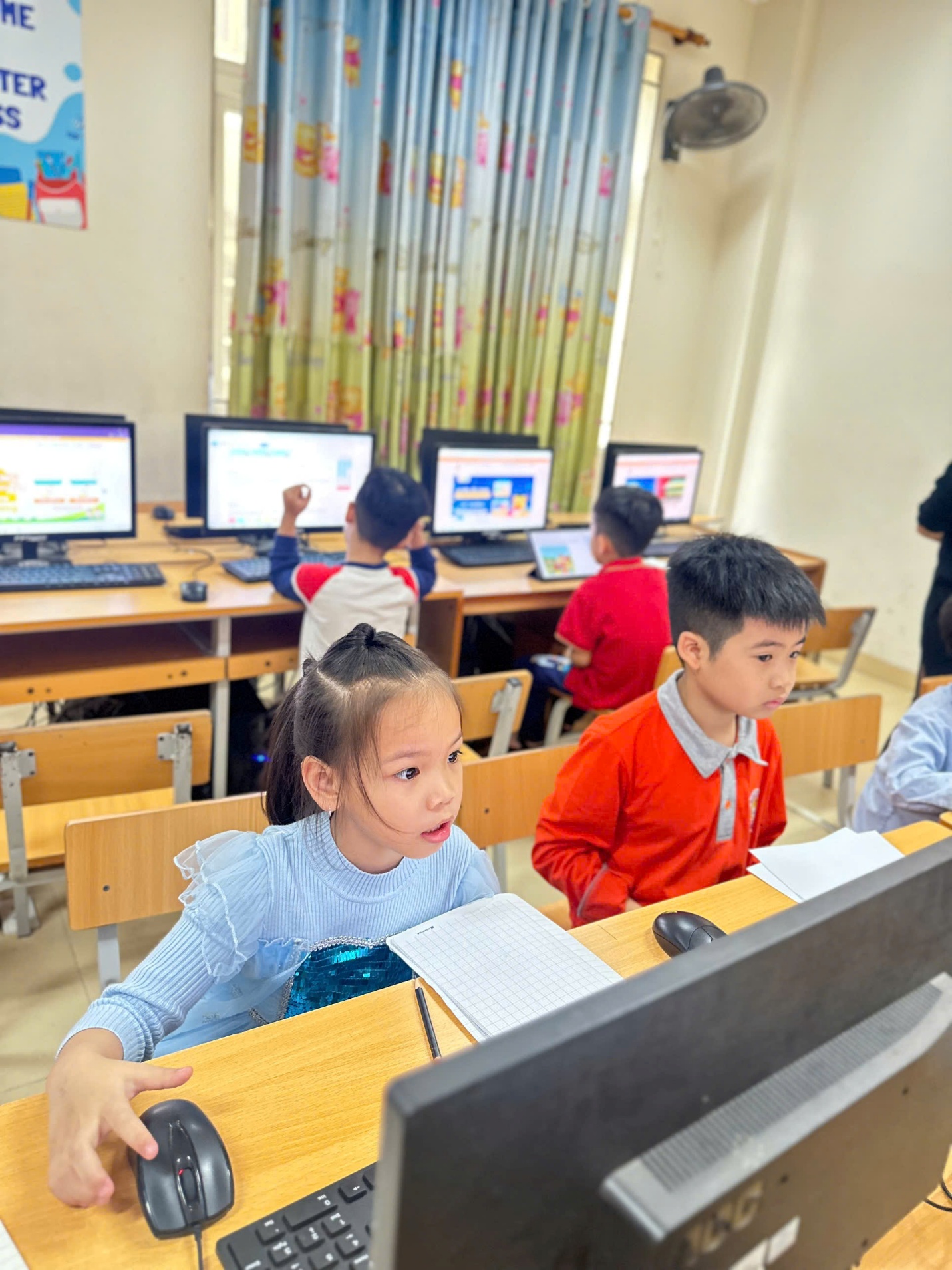A group of children sitting at desks in a classroom

AI-generated content may be incorrect.