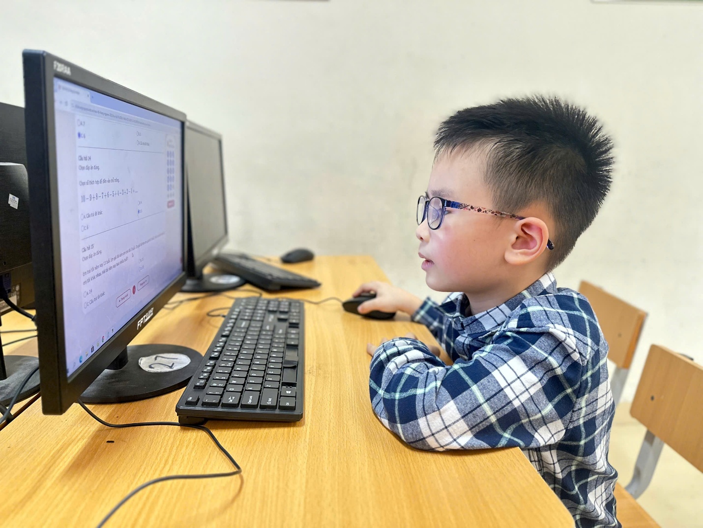 A child sitting at a desk with a computer

AI-generated content may be incorrect.