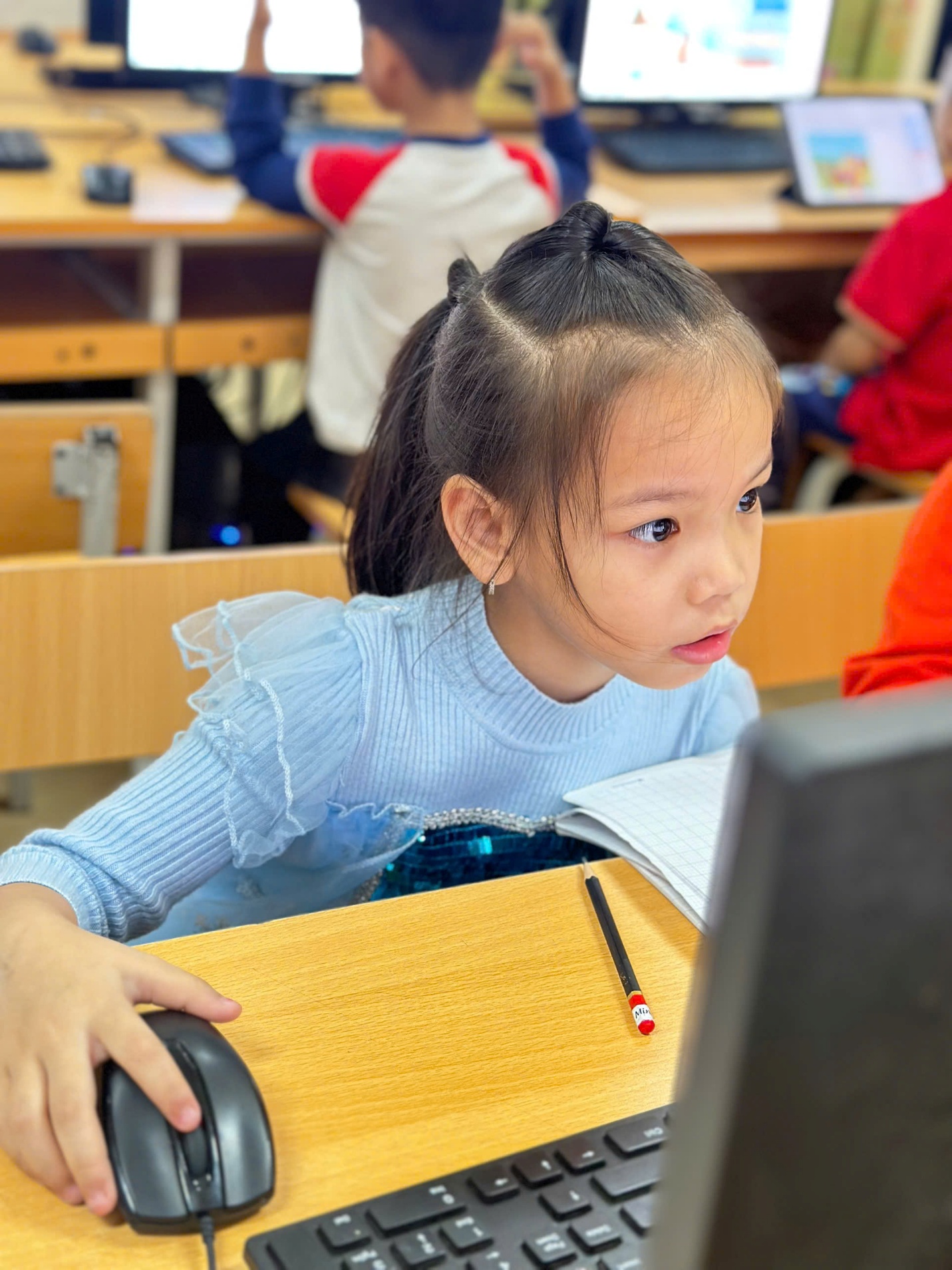 A child sitting at a desk with a computer

AI-generated content may be incorrect.