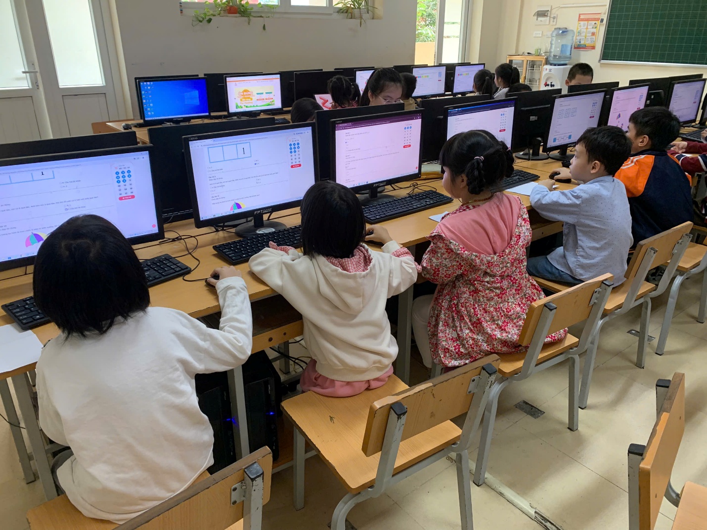 A group of children sitting at computers

AI-generated content may be incorrect.