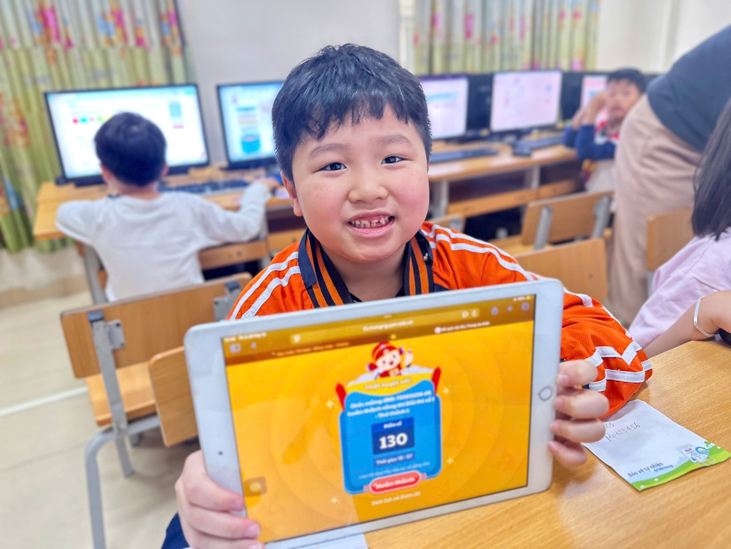 A child holding a tablet

AI-generated content may be incorrect.