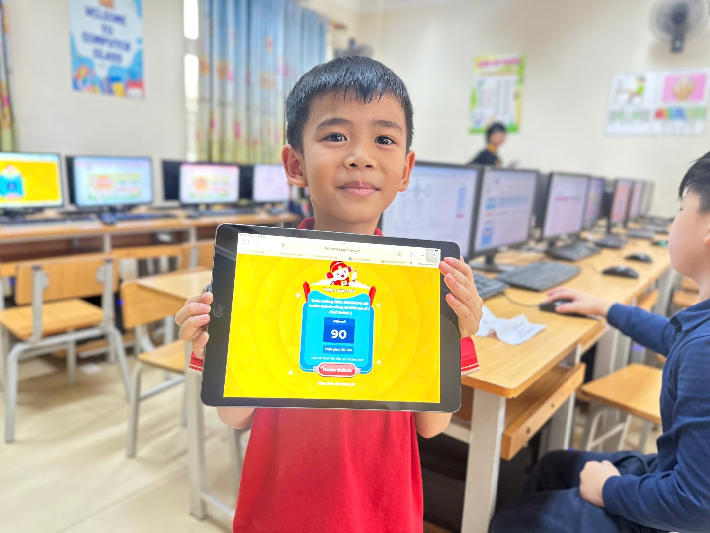 A child holding a tablet in front of a computer

AI-generated content may be incorrect.