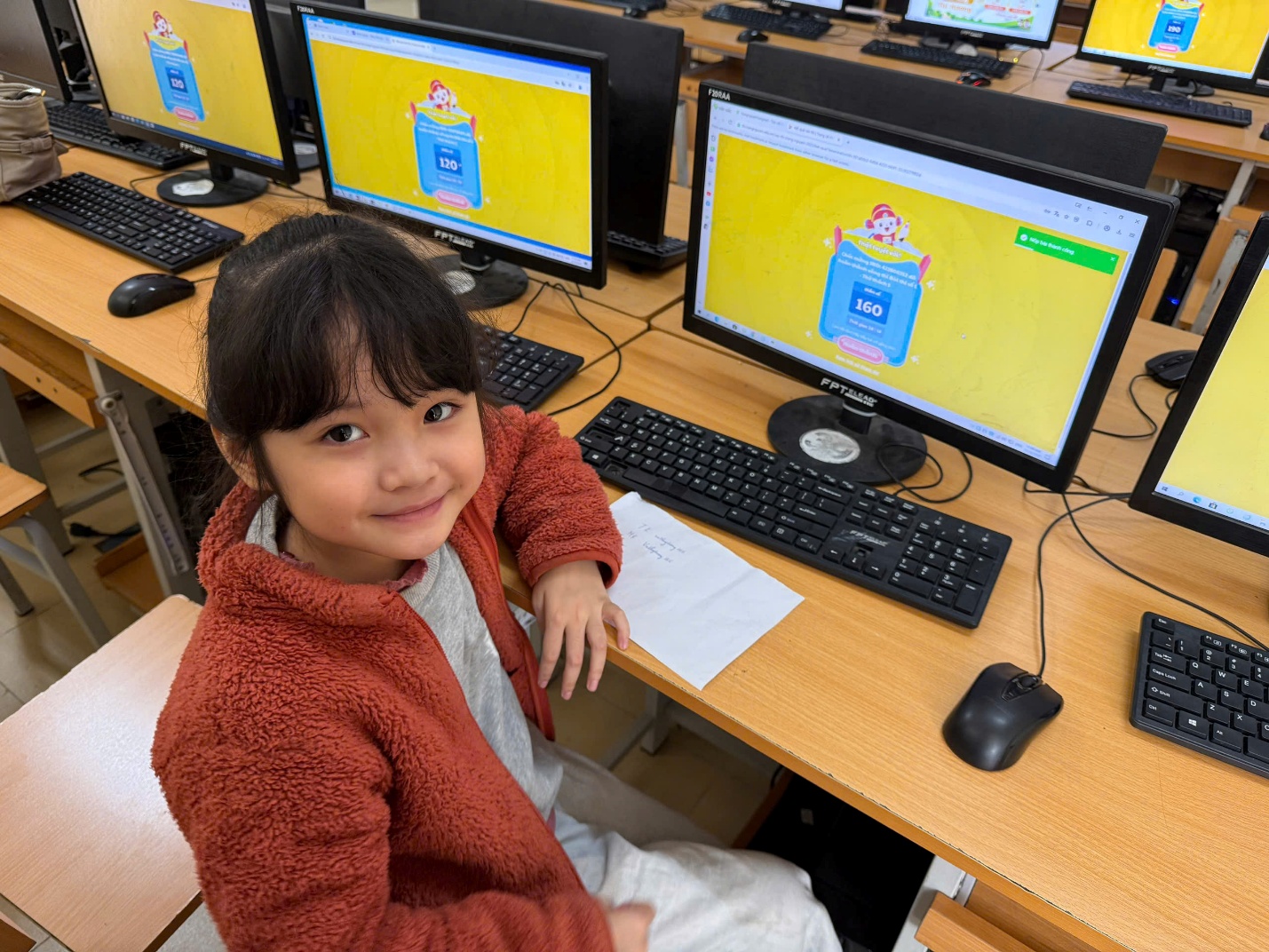 A child sitting at a desk with computers

AI-generated content may be incorrect.