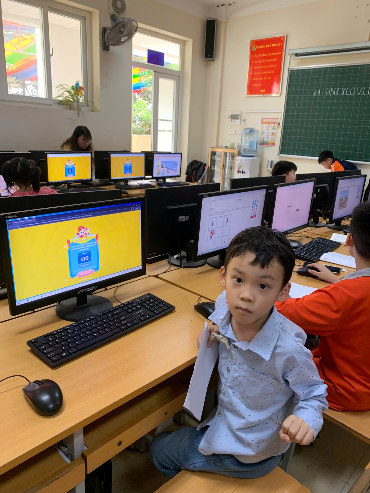 A child sitting at a desk with computers in front of him

AI-generated content may be incorrect.