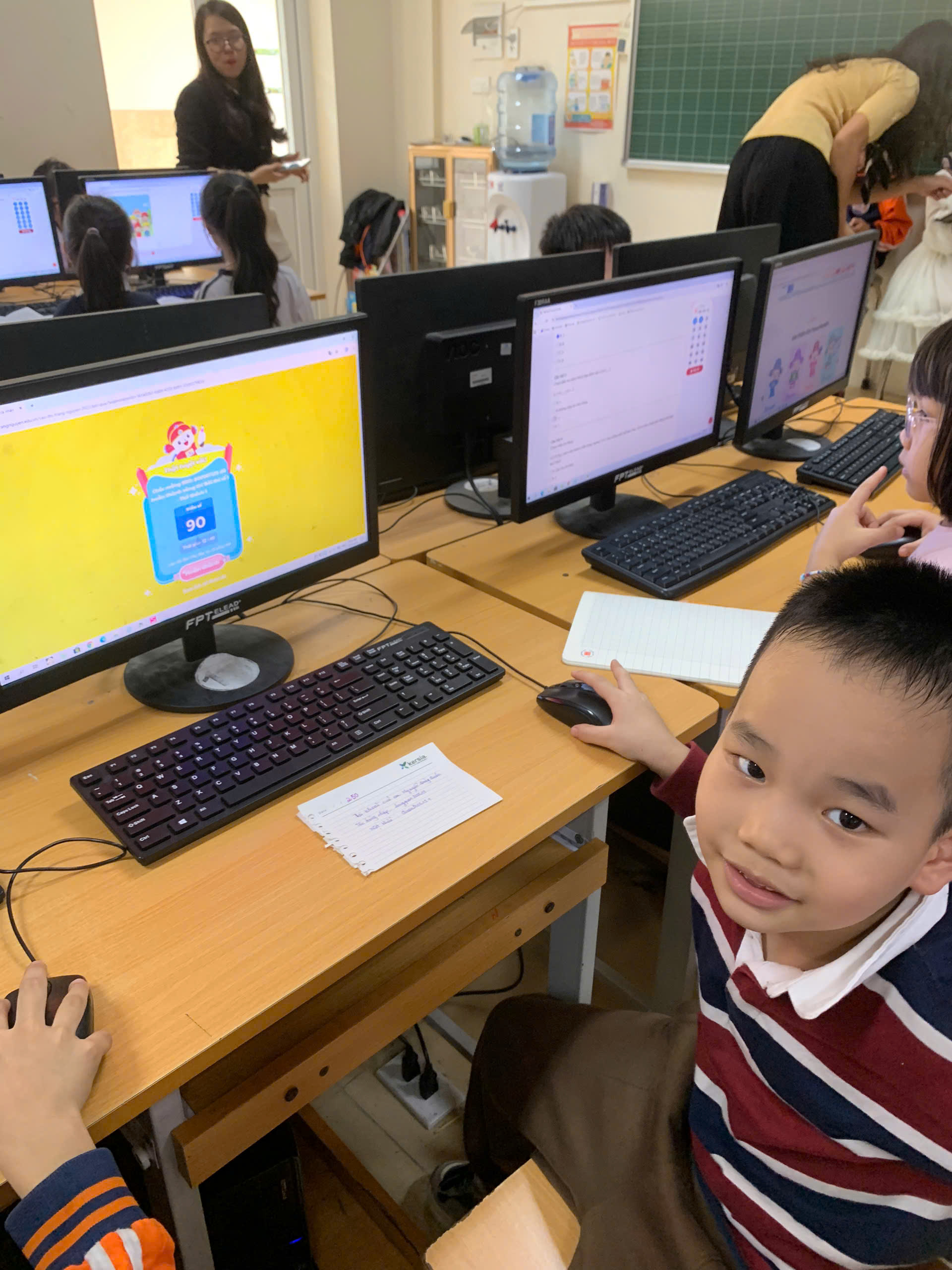 A child sitting at a desk with computers

AI-generated content may be incorrect.