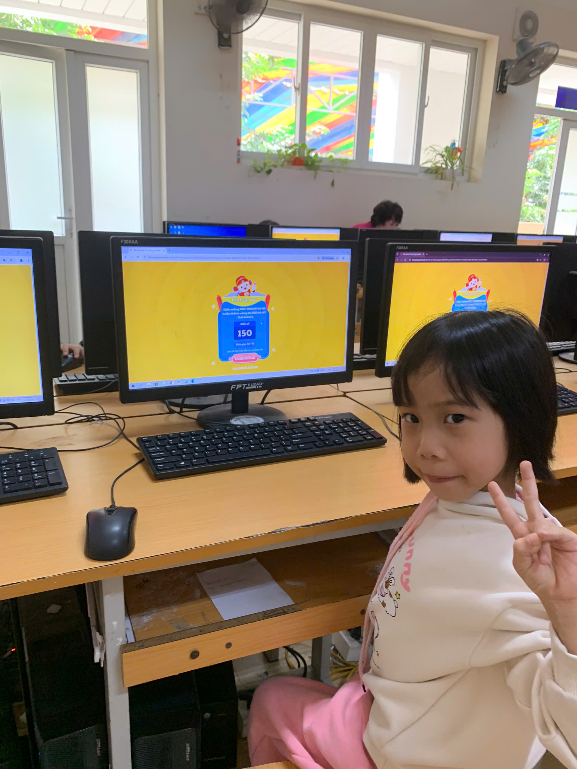A child sitting in front of computers

AI-generated content may be incorrect.