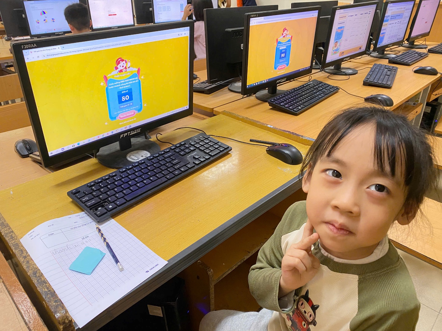 A child sitting in front of computers

AI-generated content may be incorrect.