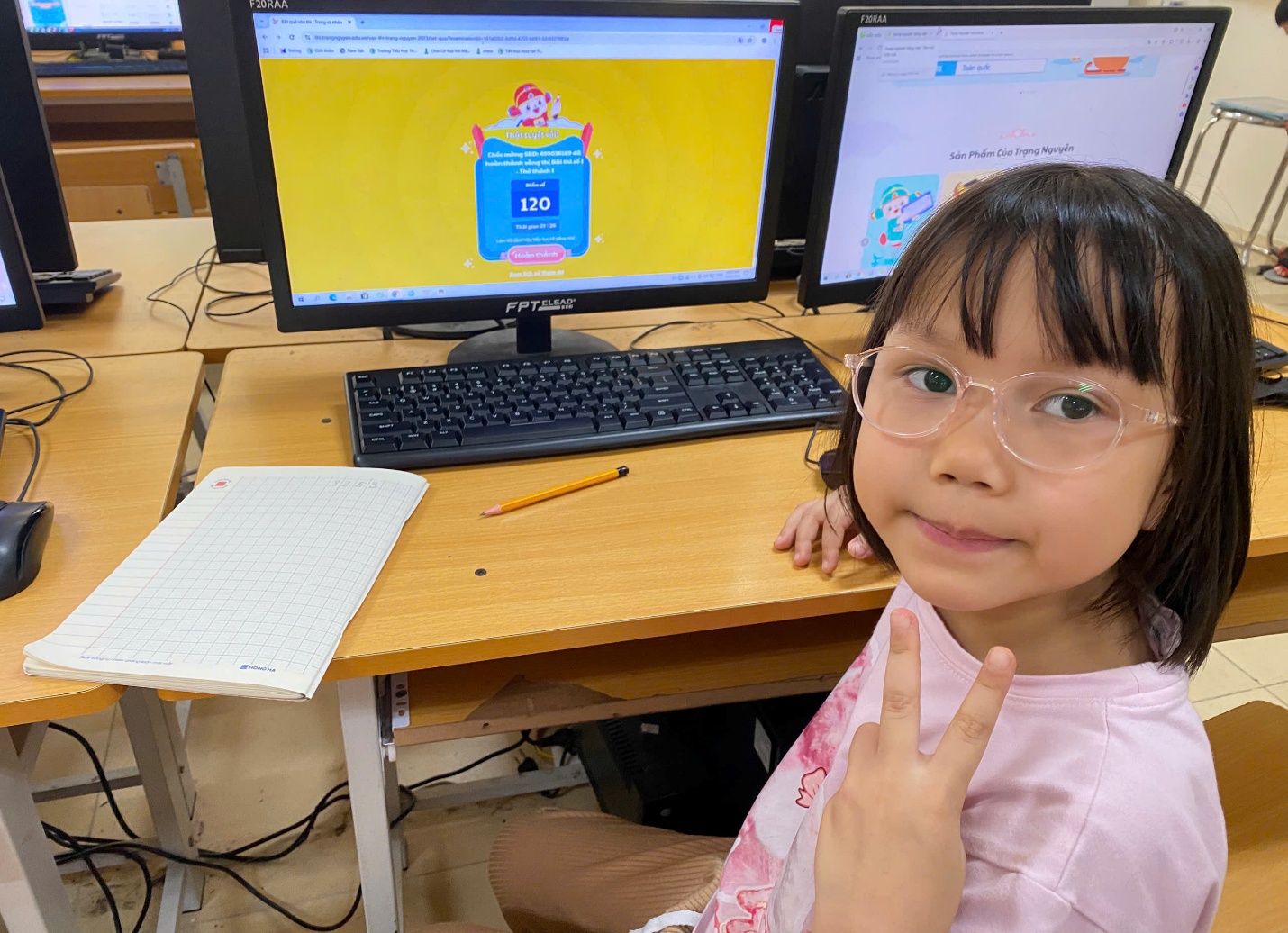 A child sitting at a desk with a computer and a peace sign

AI-generated content may be incorrect.