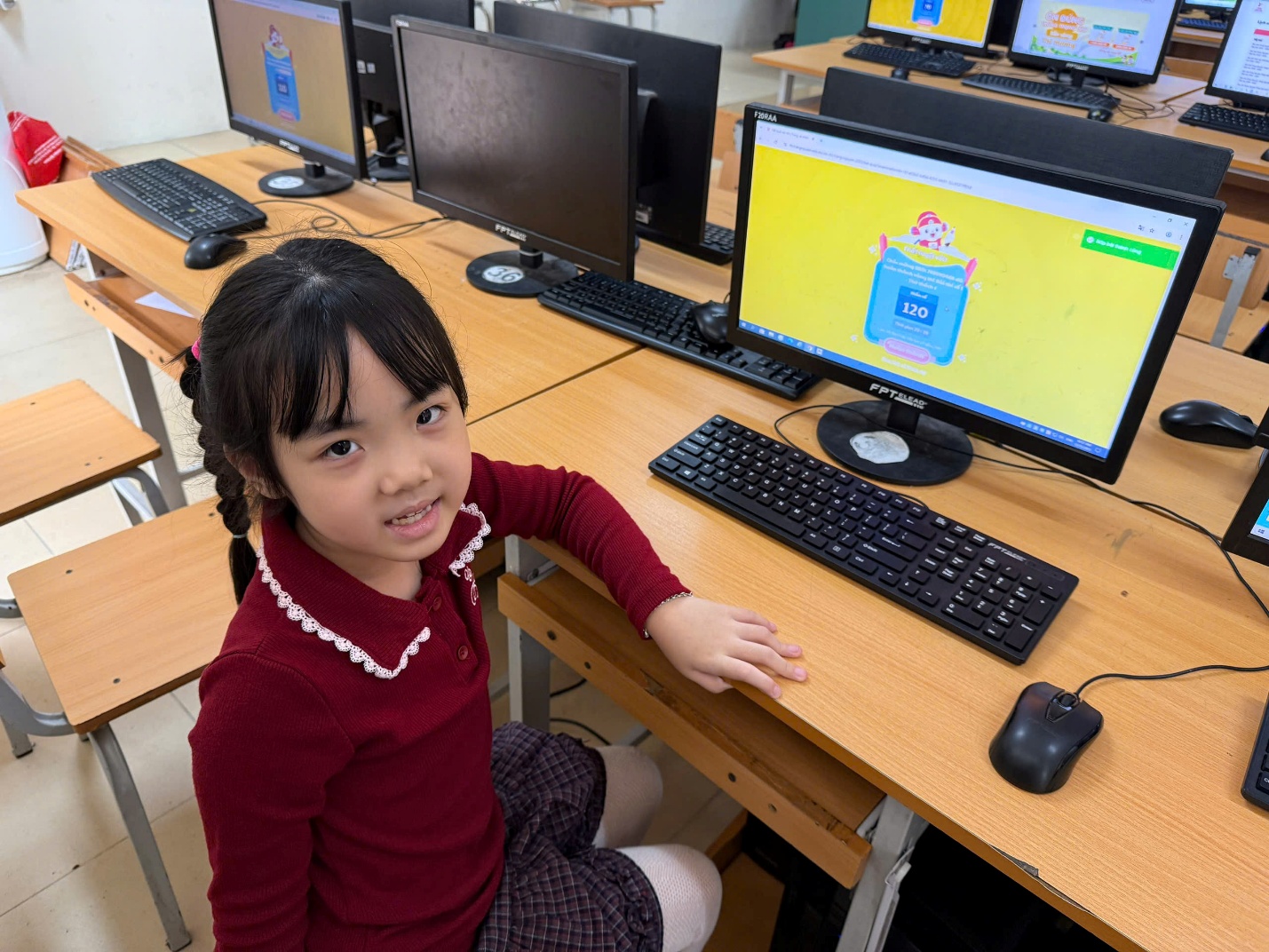 A child sitting at a desk with computers

AI-generated content may be incorrect.
