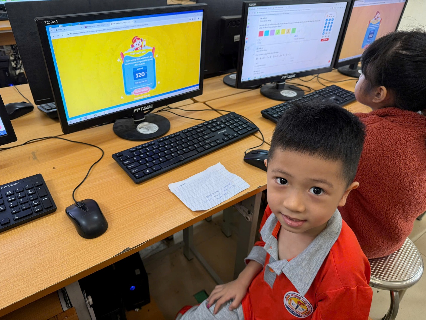 A child sitting in front of a computer

AI-generated content may be incorrect.