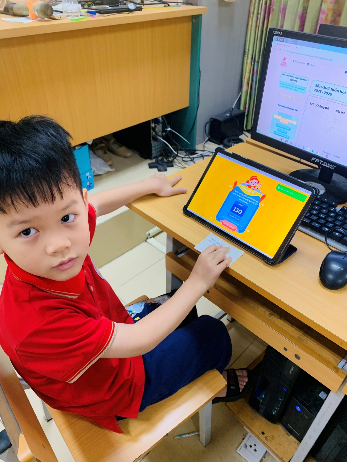 A child sitting at a desk with a computer

AI-generated content may be incorrect.