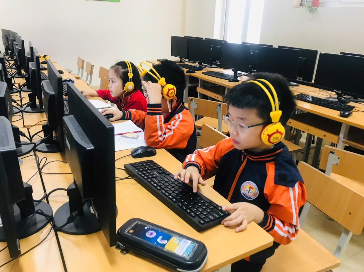 A group of children in a classroom using computers

AI-generated content may be incorrect.