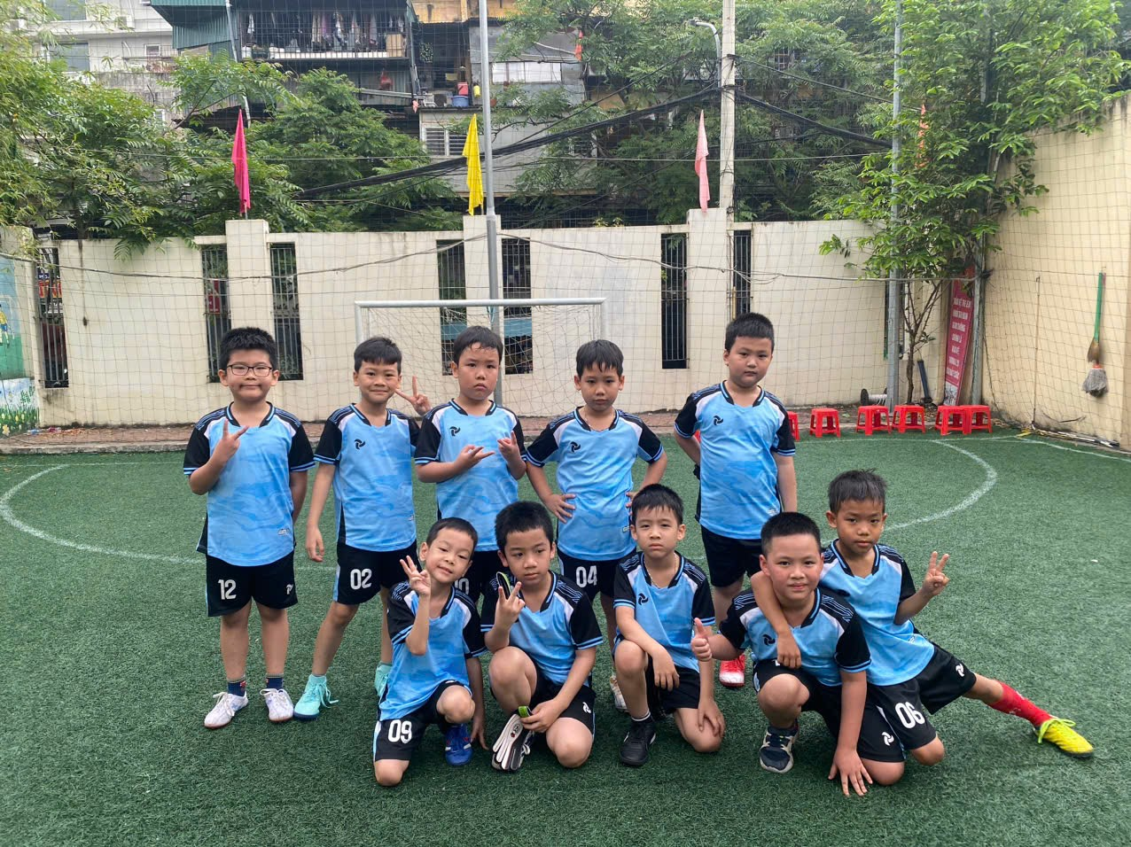 A group of boys in blue uniforms posing for a picture

AI-generated content may be incorrect.