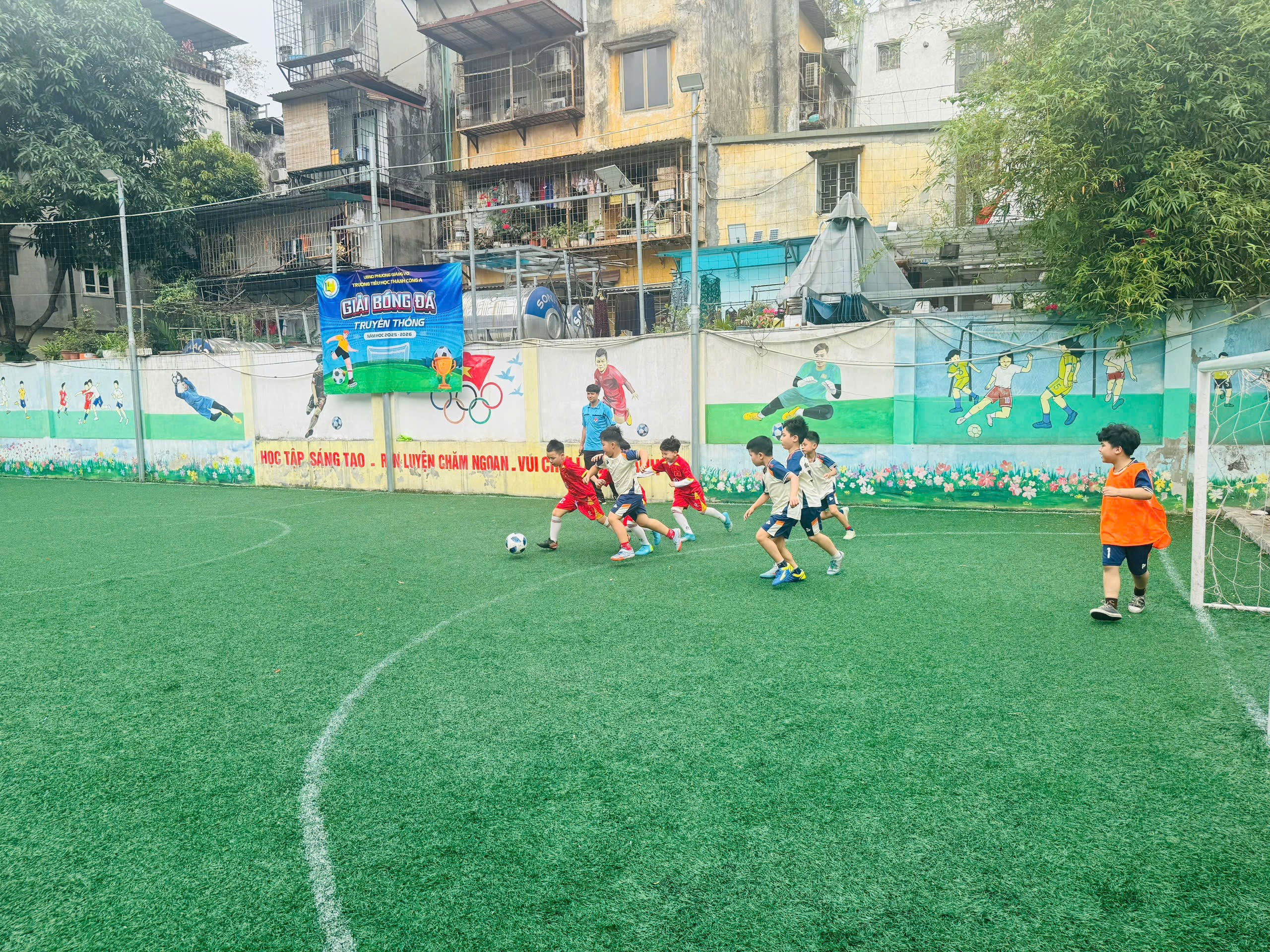 A group of kids playing football on a field
AI-generated content may be incorrect.