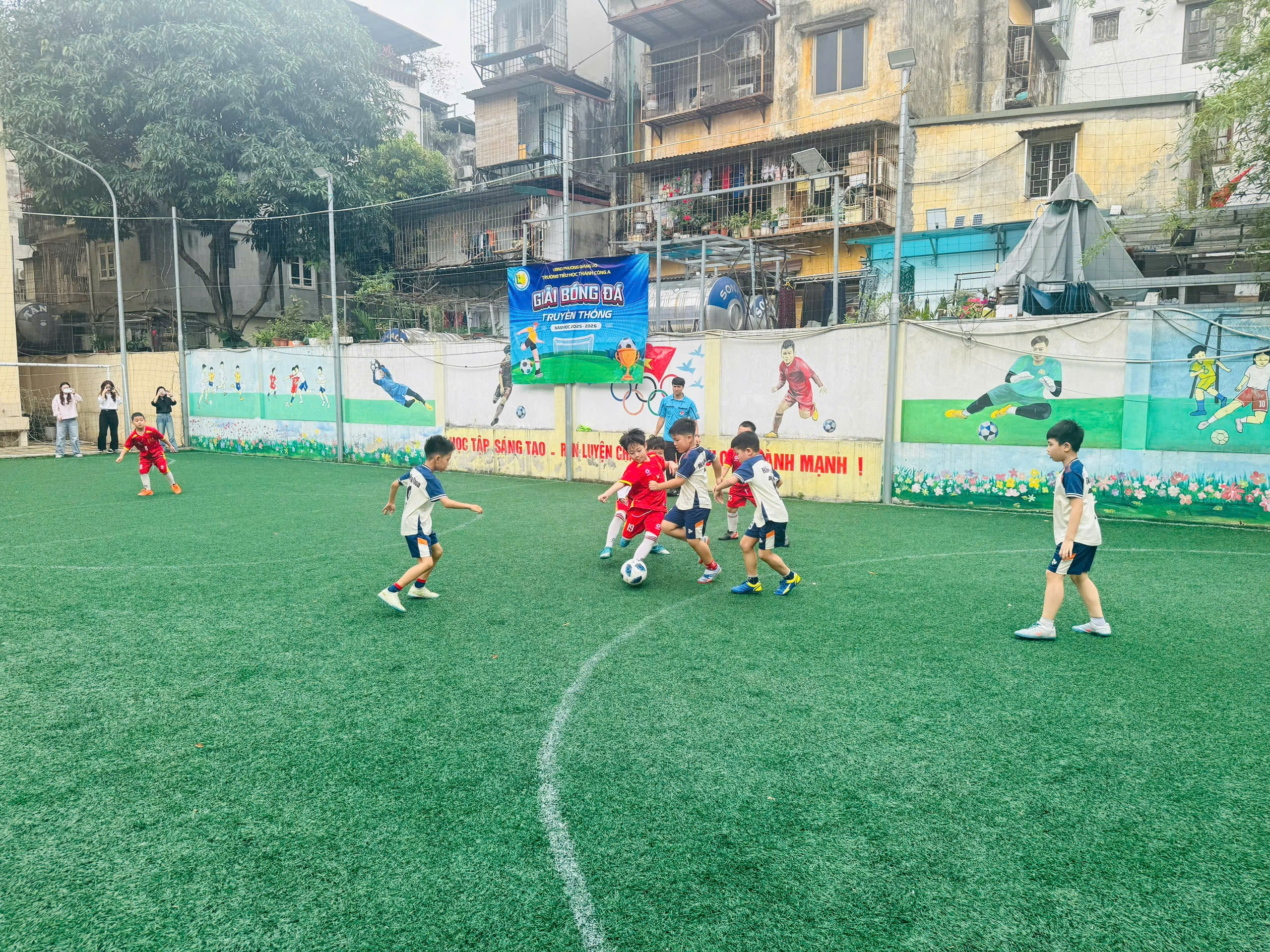 A group of kids playing football on a field
AI-generated content may be incorrect.