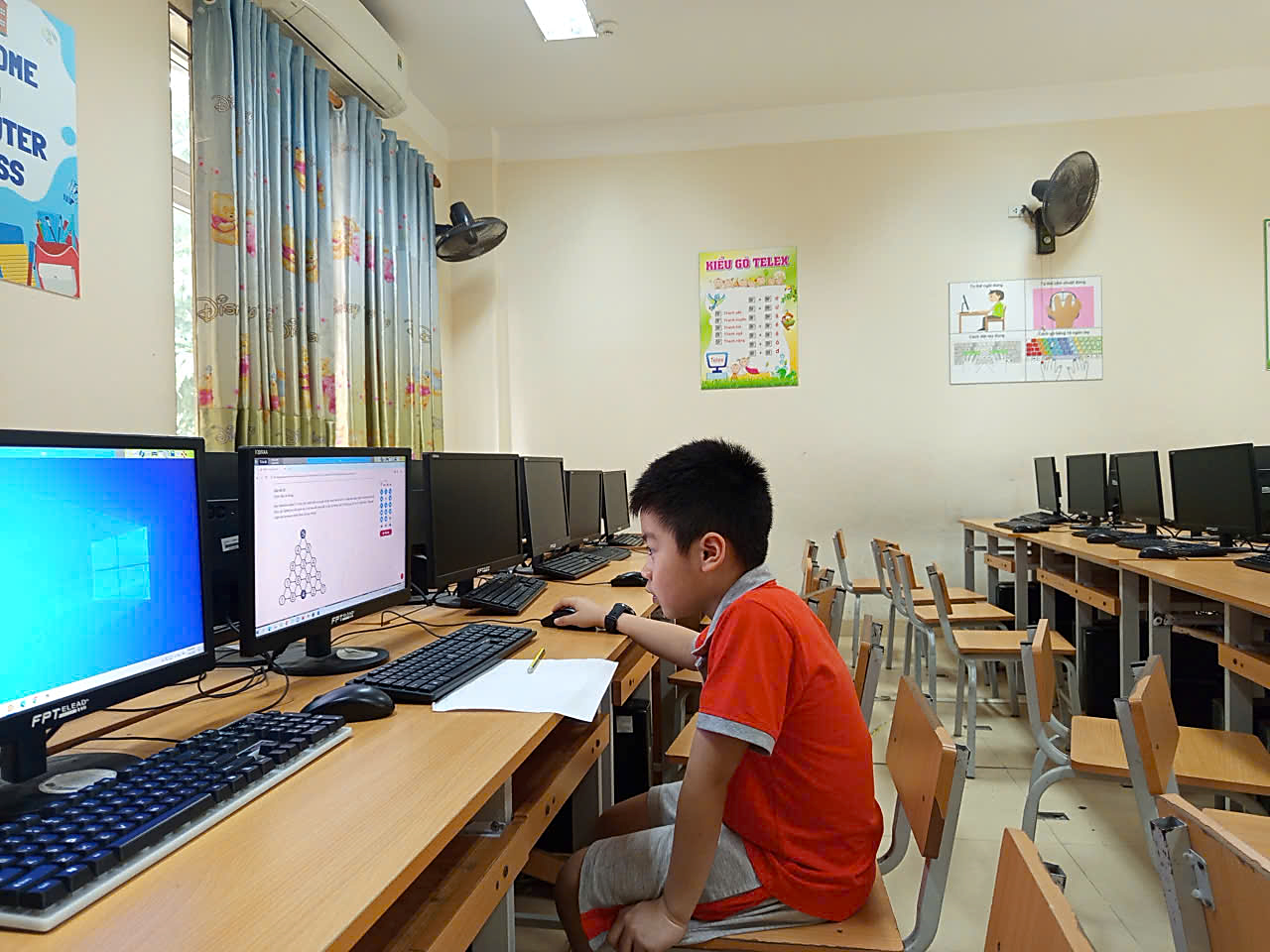 A child sitting at a desk in front of computers

AI-generated content may be incorrect.