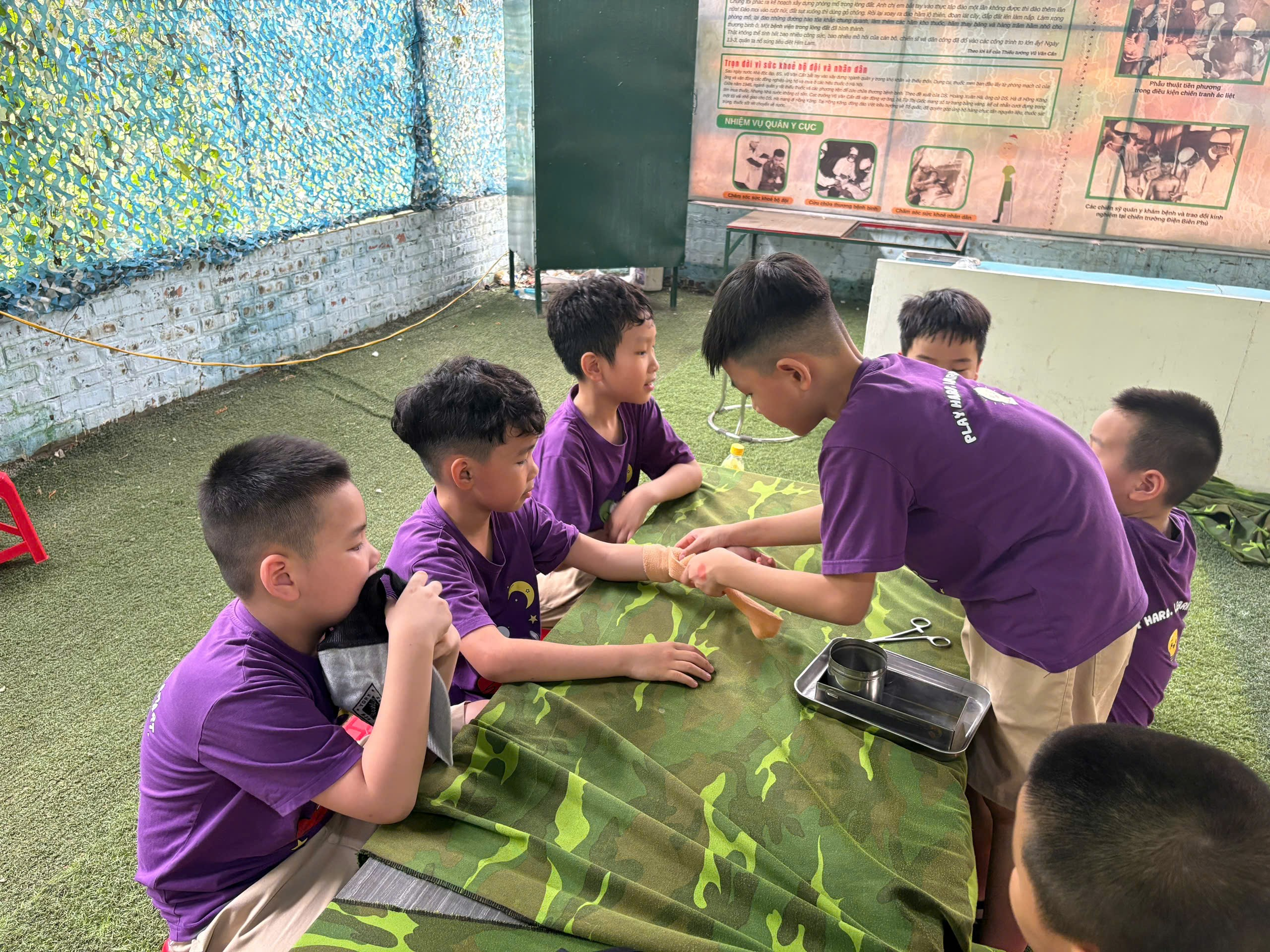 A group of boys in purple shirts sitting around a table

AI-generated content may be incorrect.
